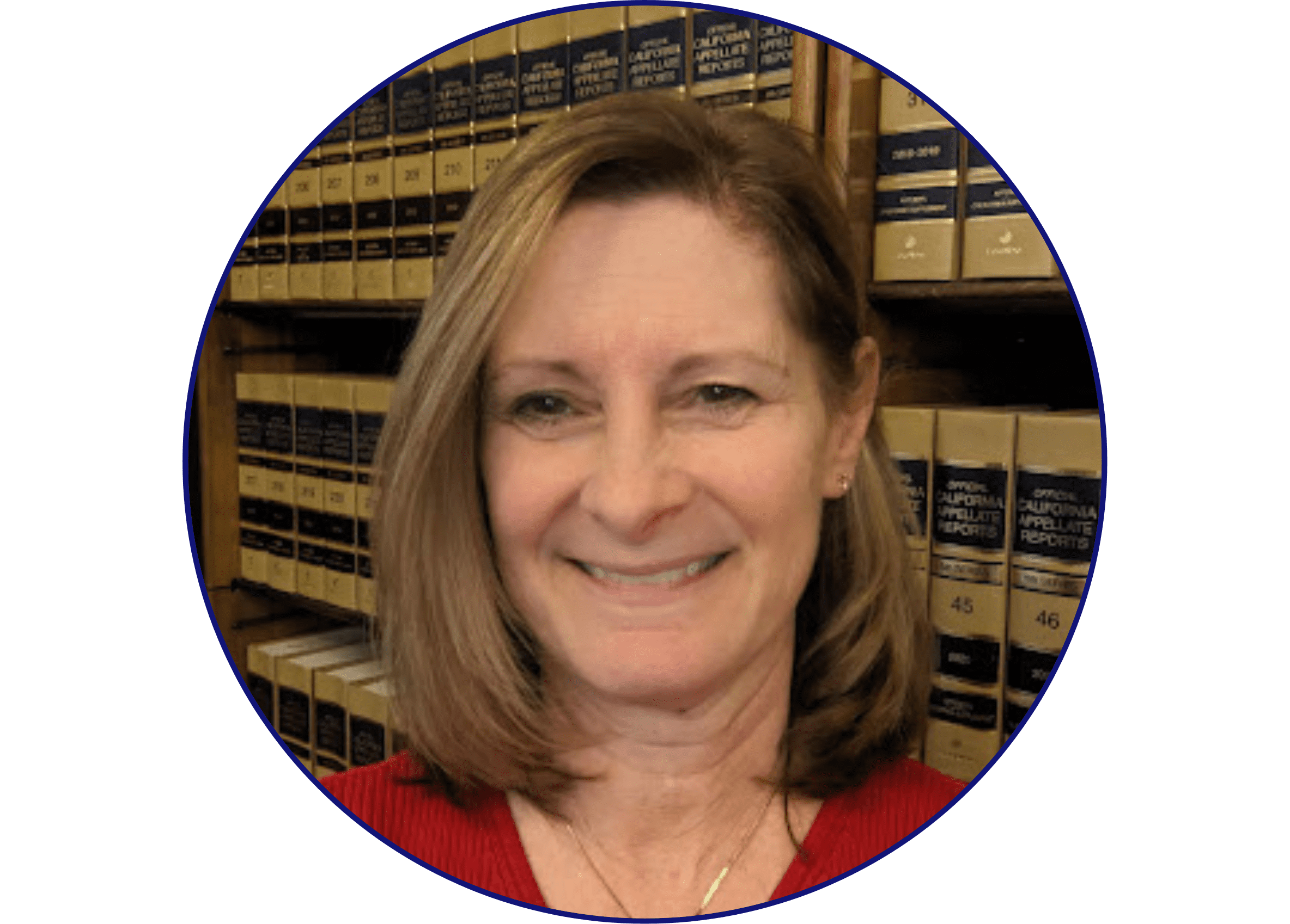 A woman with shoulder-length light brown hair, wearing a red top, smiles in front of shelves filled with legal books.